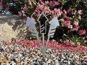 METAL FIREWORKS LAWN STAKE IN GARDEN, SHOWN IN RAW STEEL