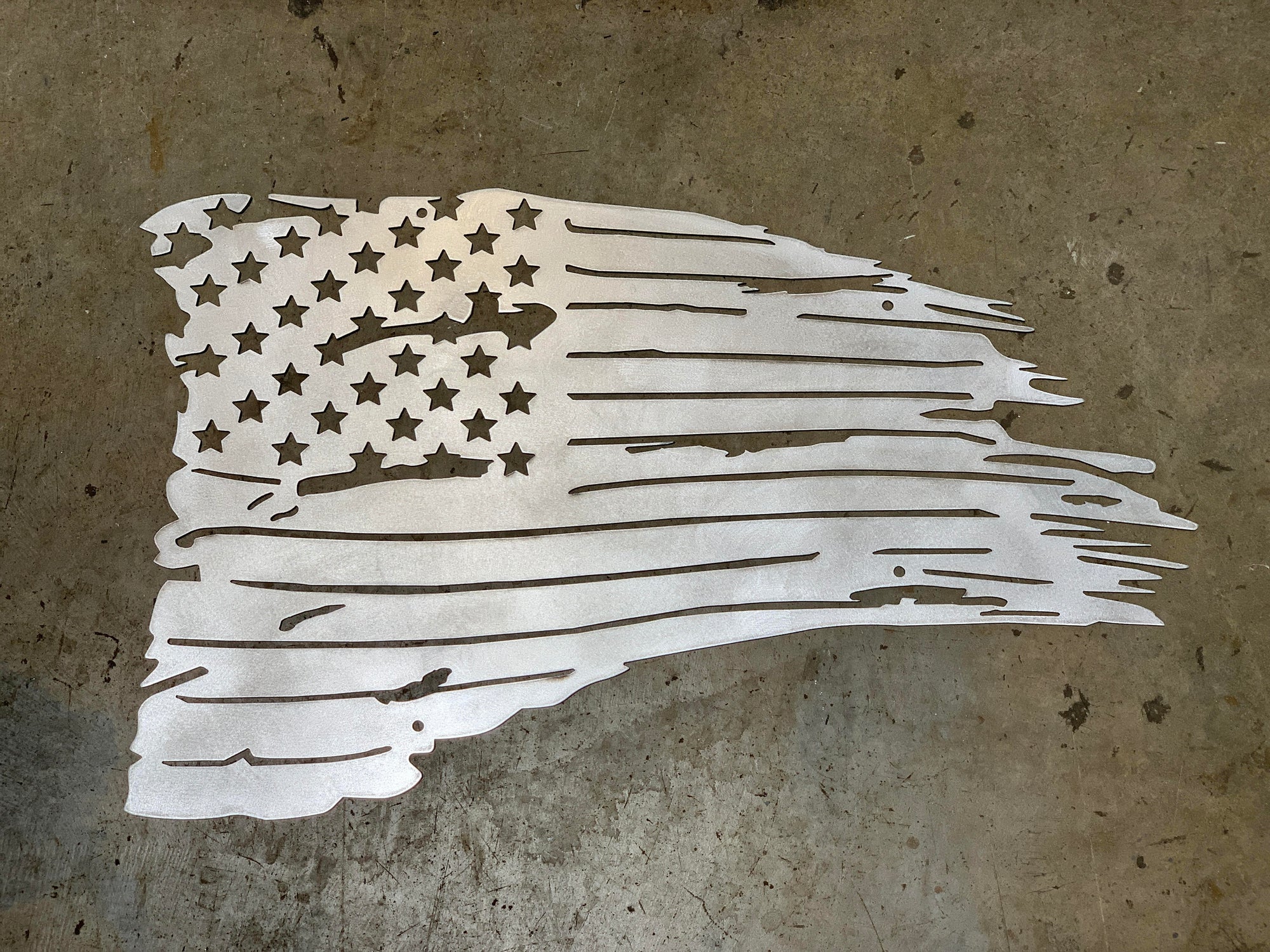 Metallic American flag cutout on a textured surface