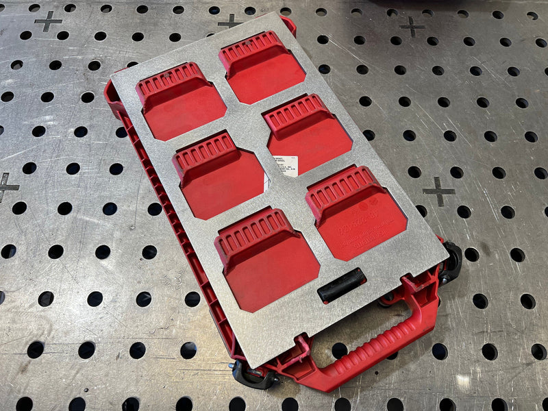 Red tool organizer on a metal pegboard