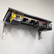 Wall-mounted tool holder with two power tools on a white wall