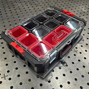 Heavy-duty steel Bauer modular toolbox mounting plate attached to a red Harbor Freight storage organizer box.