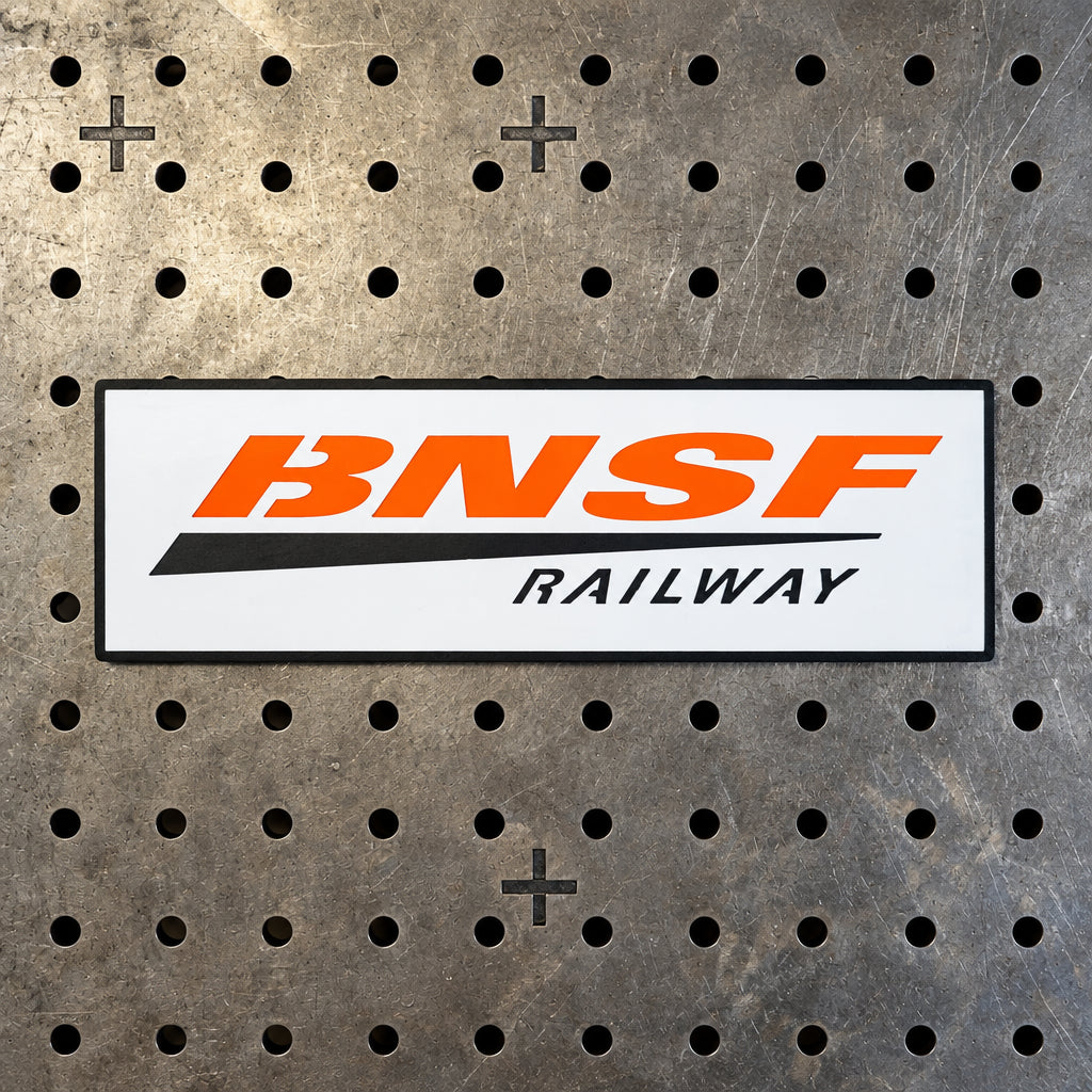 Large 24.5-inch BNSF Railway metal sign made of 14-gauge steel for train room wall art—professional orange and black heritage style.