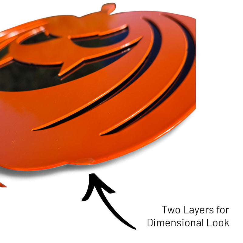 Close-up side view of an orange steel jack-o'-lantern showing the dual-layer construction that creates a 3D dimensional look and added durability.