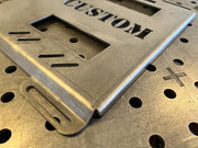 mounting plate for klein, raw steel with lightning bolt cut-out design, mounting hole close up